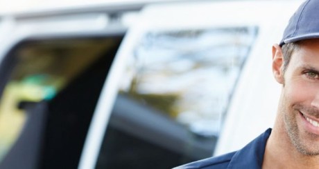 small business owner in front of vehicle