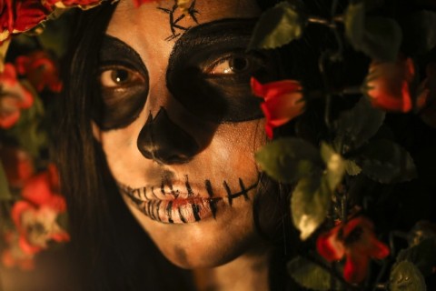 A woman with skull face paint for Dia de Los Muertos