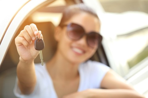 woman holding keys to new car