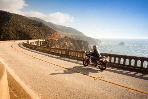 man driving motorcycle down the coast